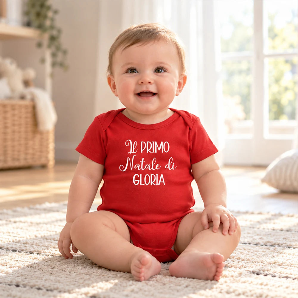 Neonata con body rosso personalizzato con la scritta Il primo Natale di Gloria